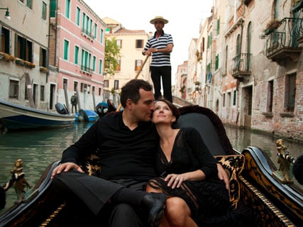 Man and woman on a gondola ride in Venice